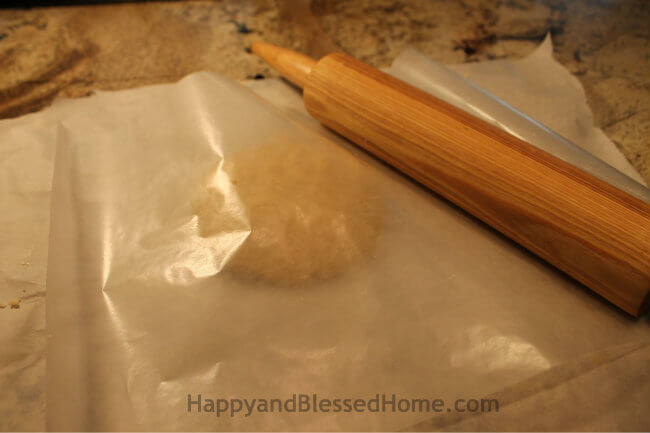 Parchment Paper on Bottom and Wax Paper on top for the Snowflake Cookie Recipe and Cookie Decorating Tutorial HappyandBlessedHome.com