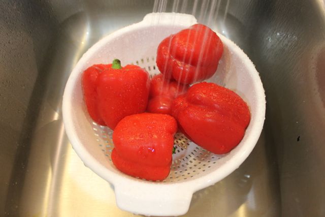 Washing Red Bell Peppers for Honey Lemon Chicken and Big Hero 6 Party from HappyandBlessedHome.com