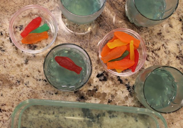 Add colored gummy fish to jelled Capri Sun Roarin' Waters to create Bubble Guppies Jello Recipe from HappyandBlessedHome