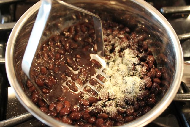 Mash the black beans to create a thicker sauce