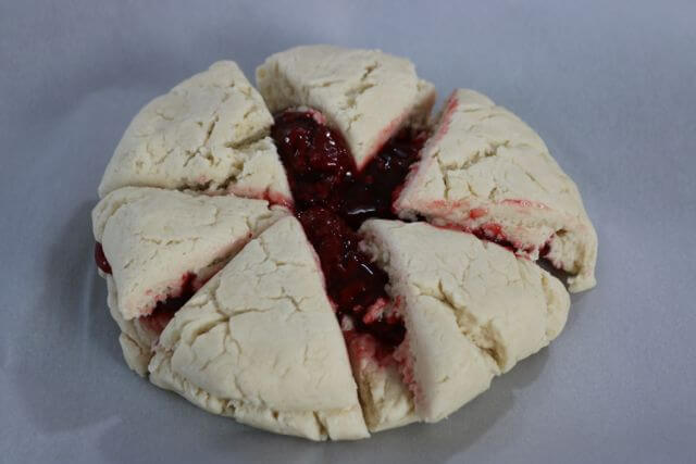 cut either six or eight triangles from the raspberry scone dough shape