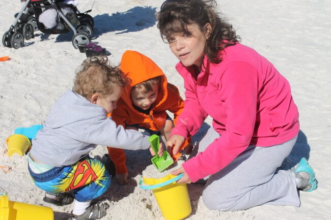 Building sandcastles keeps mommy and the boys busy