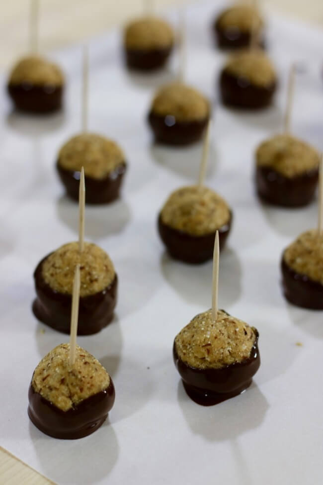 Dry these SKINNY Peanut Butter and Chocolate Buckeyes on parchment paper
