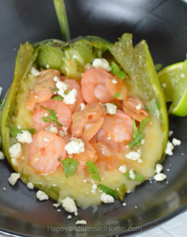 Garnish and season these Cheese, Clam and Shrimp Stuffed Poblano Peppers to taste - serve with lime