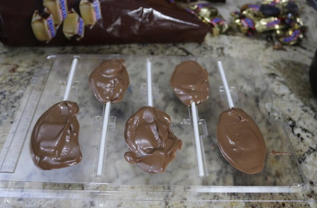 Tasty and festive these chocolate football pops are filled with SNICKERS minis