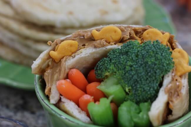 Kid-friendly and easy Flat Bread recipe to help kids learn how to make their own sandwiches at home - topped with Goldfish crackers and peanut butter