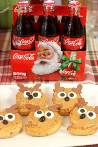 Peanut butter frosted reindeer rolls and holiday inspired glas Coca-Cola bottles
