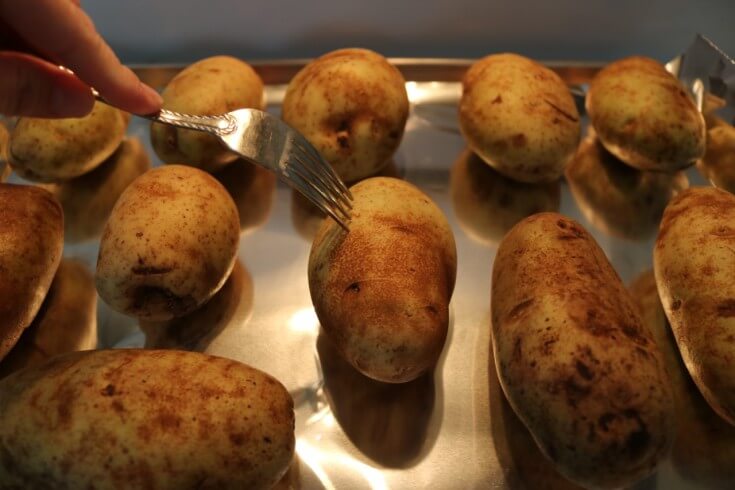 Poke holes with a fork to create Bacon Jalapeño Popper Twice Baked Potatoes