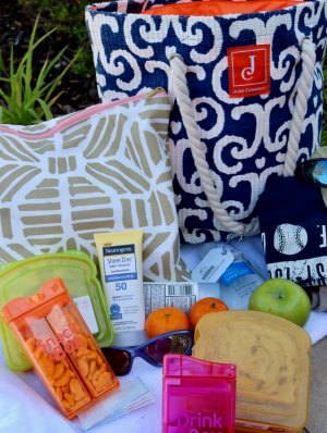 10 Helpful Outdoor Playdate Essentials for Moms and Kids with waterproof bag and containers for snacks