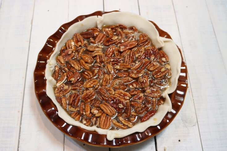 Pour corn syrup over the pecans for a Southern Pecan Pie Recipe